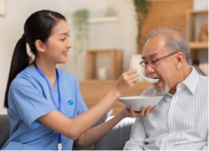 caregiver feeding elderly